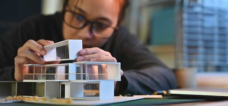 architect student building model for final capstone project